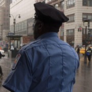 Photo of a uniformed police officer from behind to protect his identity